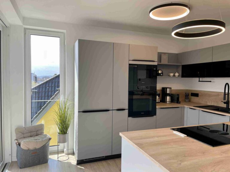Die moderne Einbauküche mit Zugang auf den Balkon